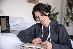 Woman writing on a notebook image